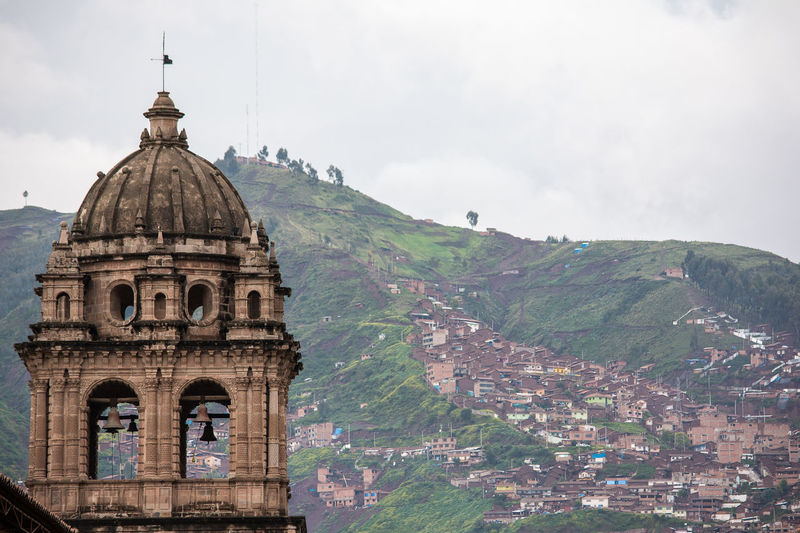 Bell tower of cusco cathedral against town