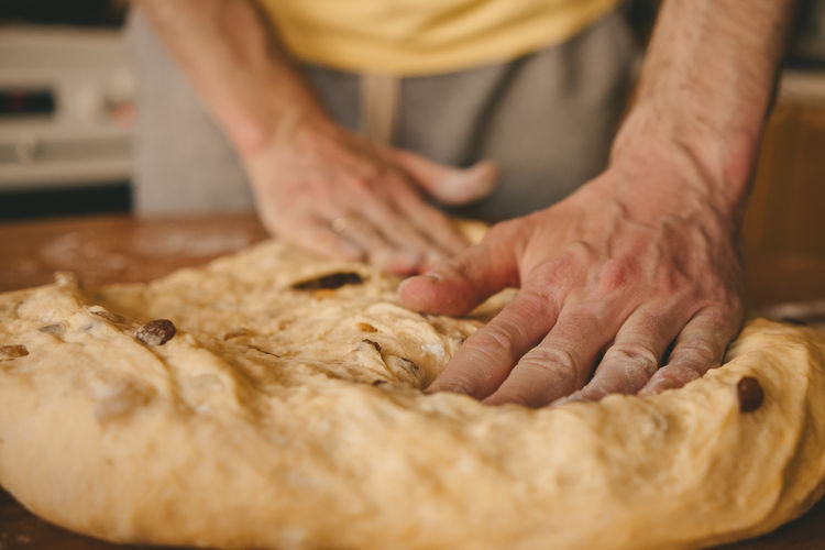 Male hands prepare dough