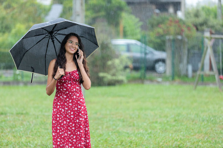 Young woman holding umbrella