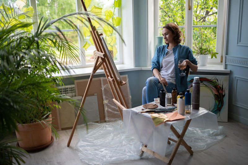 Woman sitting on table at home