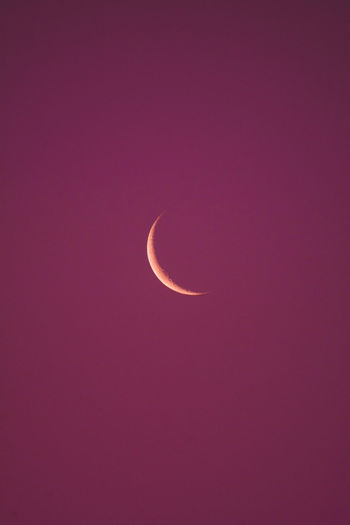 Low angle view of half moon against sky at night