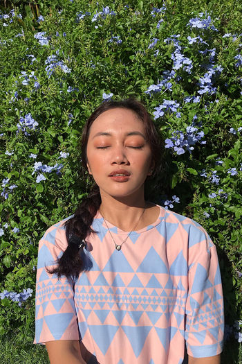 Portrait of a beautiful young woman with eyes closed