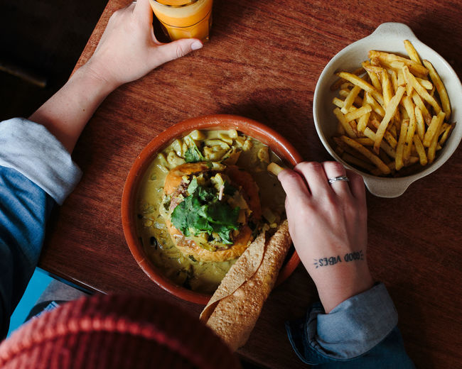 not healthy eating Adult Adults Only Close-up Day Eating Food Food And Drink Freshness Healthy Eating High Angle View Holding Human Body Part Human Hand Indoors Indulgence Lifestyles Men People Plate Ready-to-eat Real People Refreshment Table Women Young Adult