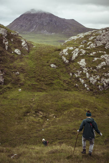 Women walk wild mountains in scottish highlands