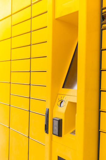 Modern yellow shopping locker. bar code reader for skans qr code on mobile phone self-service locker