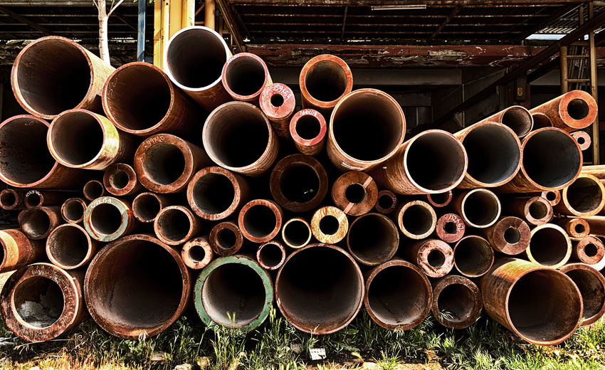Rusty pipes on field