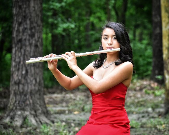 Young woman holding a flute 