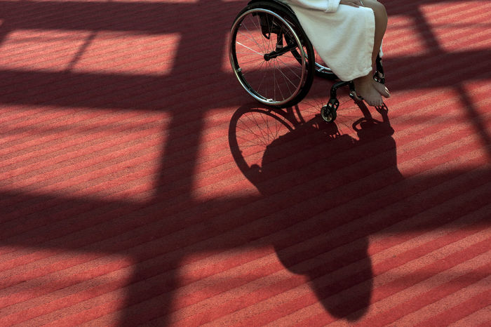 Low section of woman sitting on wheelchair