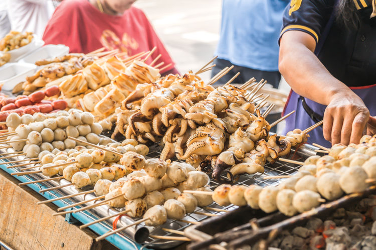 Charcoal grilled food brochette for sale at a local market in bangkok, thailand.