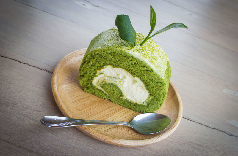High angle view of matcha green tea cake served in plate on table