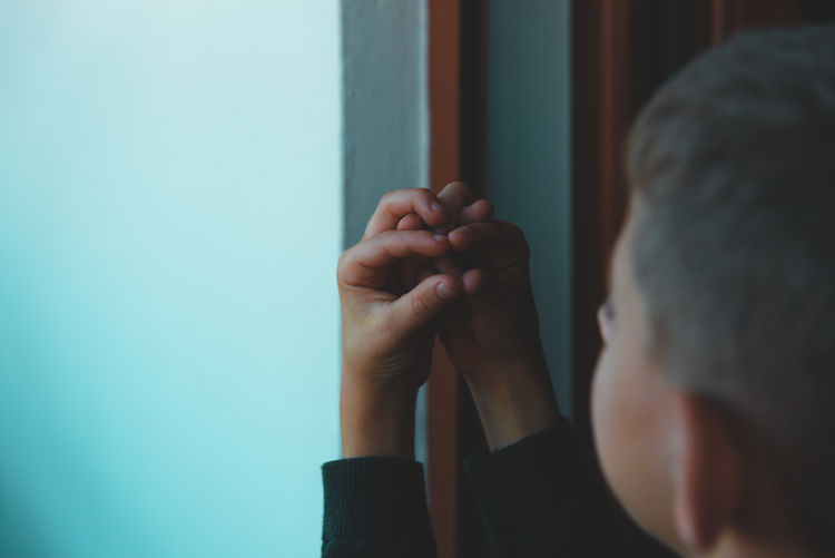 Rear view of man holding hands