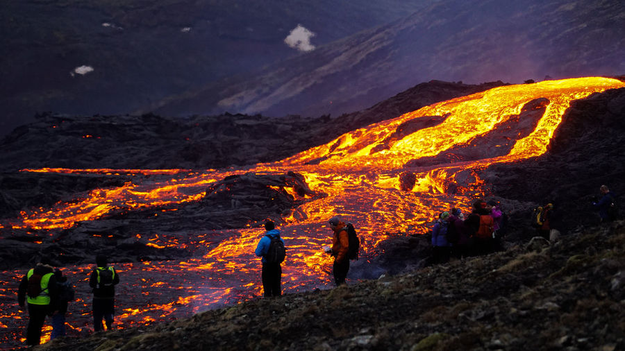 People watch a lava river in mt fagradalsfjall, southwest iceland, only 30 km away from reykjavik.