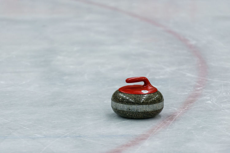 Close-up of curling stone on ice rink