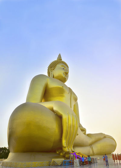 Low angle view of buddha statue against clear sky