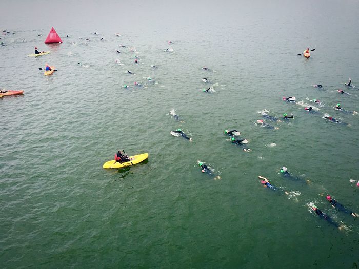 High angle view of people swimming in lake