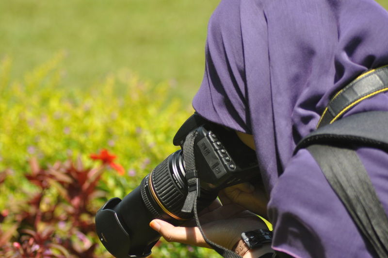 Close-up of man hand on field