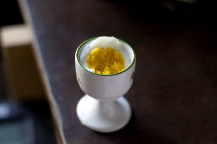 High angle view of boiled egg in cup on table