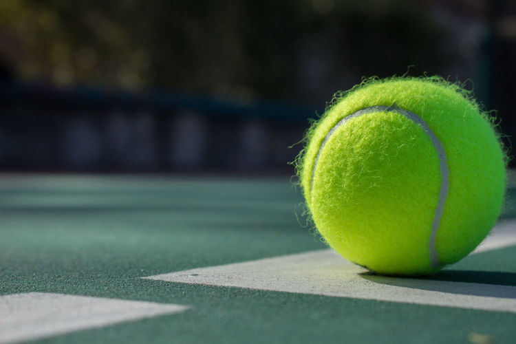 Close-up of tennis ball in court