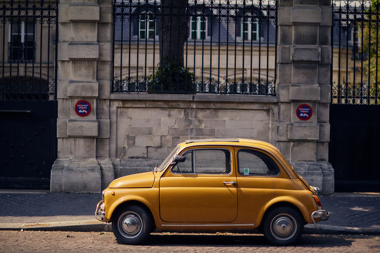 Yellow car parked in paris. bright retro car.