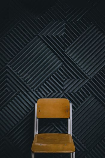 Beautiful brown chairs plus a black wall