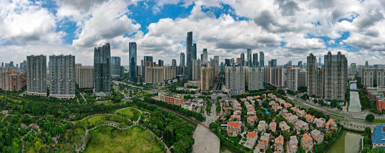 Panoramic view of modern buildings in city against sky