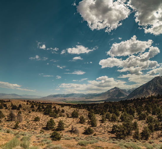 Wide angle desert landscape and mountain range with dramatic cloudy sky