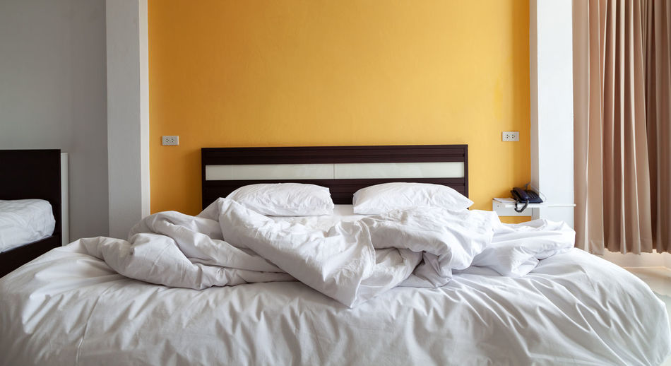 Empty bed in bedroom