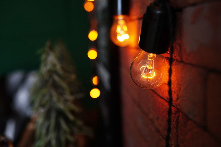 Decorative antique style light bulbs against brick wall background
