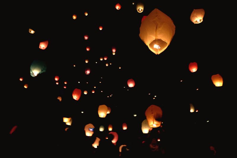 Low angle view of illuminated lanterns at night
