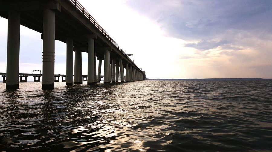 Low angle view of chesapeake bay bridge against sky during sunset