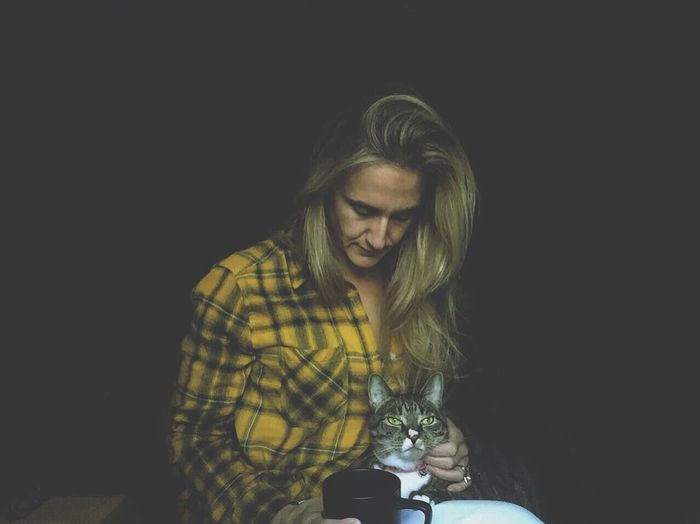 Woman holding tabby cat