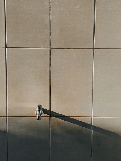 Shadow of people walking on footpath