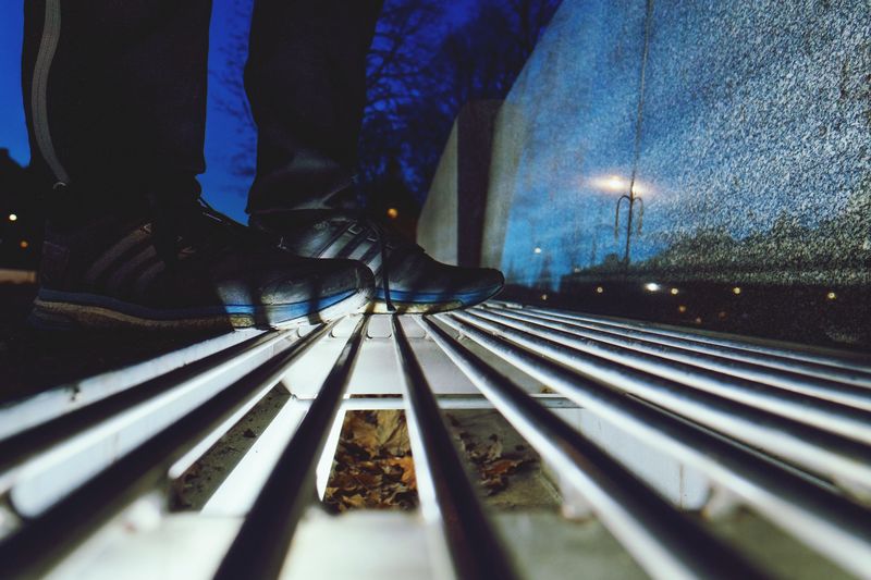 Low section of man on railroad tracks at night