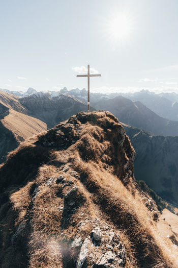 Summit with cross in german alps against blue sky