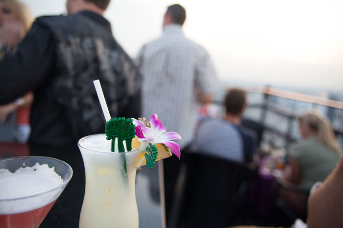 Close-up of refreshing drinks with people in background at restaurant