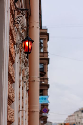 Low angle view of illuminated street light against building