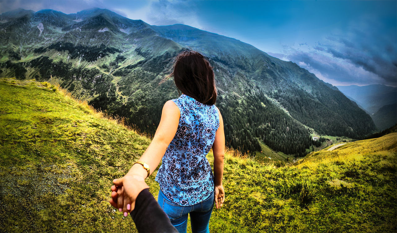 REAR VIEW OF WOMAN LOOKING AT MOUNTAIN