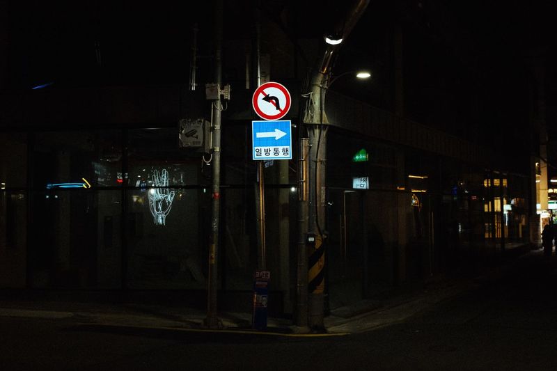 Illuminated road sign at night
