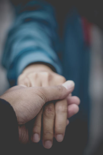 Close-up of couple holding hands