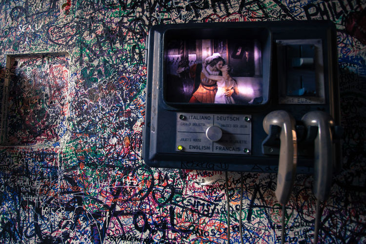 Antique telephone on graffiti wall