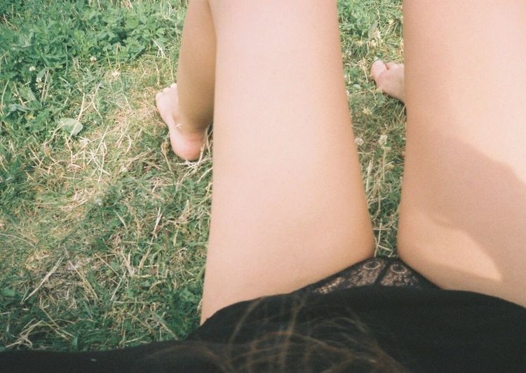 Low section of woman legs on grass
