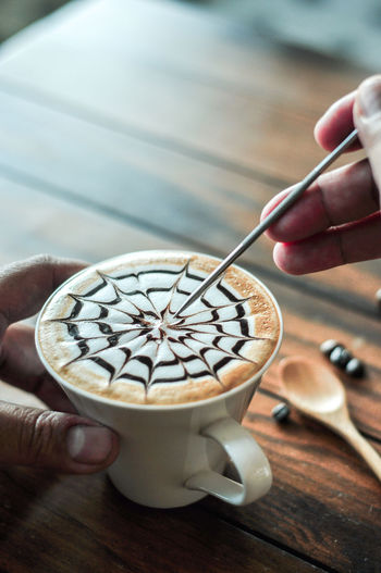 Midsection of person holding coffee cup