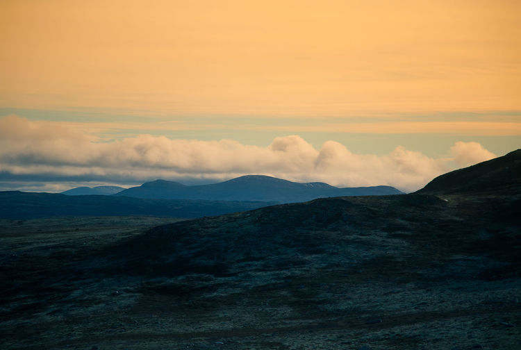 Scenic view of dramatic landscape against sky during sunset