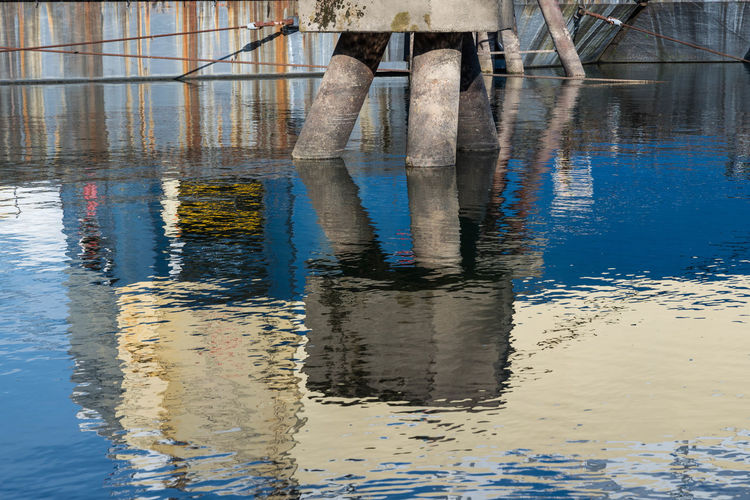 Reflection of built structure in puddle
