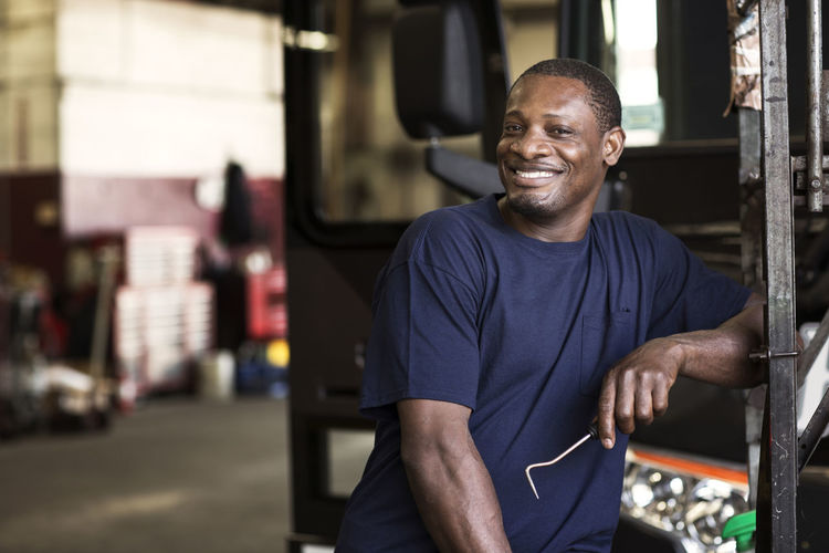 Portrait of smiling mechanic in workshop