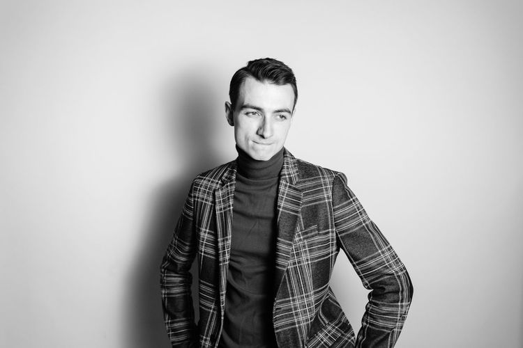Man standing against gray background