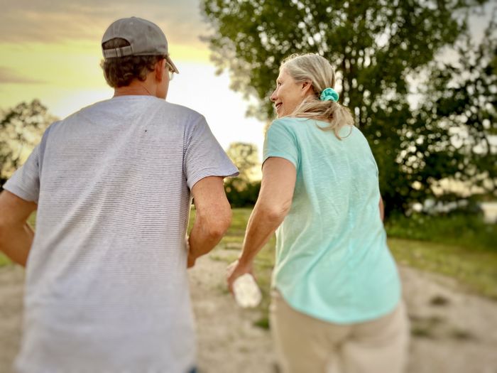 Rear view of couple standing at park