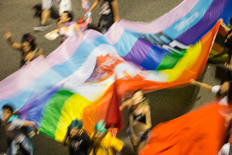 Group of people on multi colored umbrellas