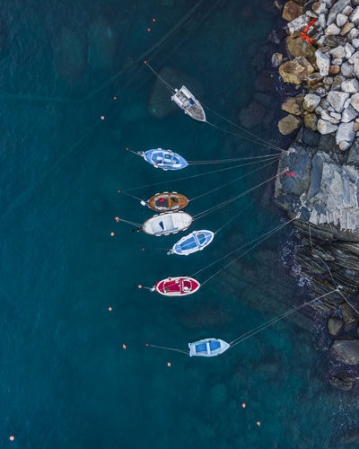 Aerial view of riomaggiore small pier and port with fishing boat, cinque terre, liguria, italy.