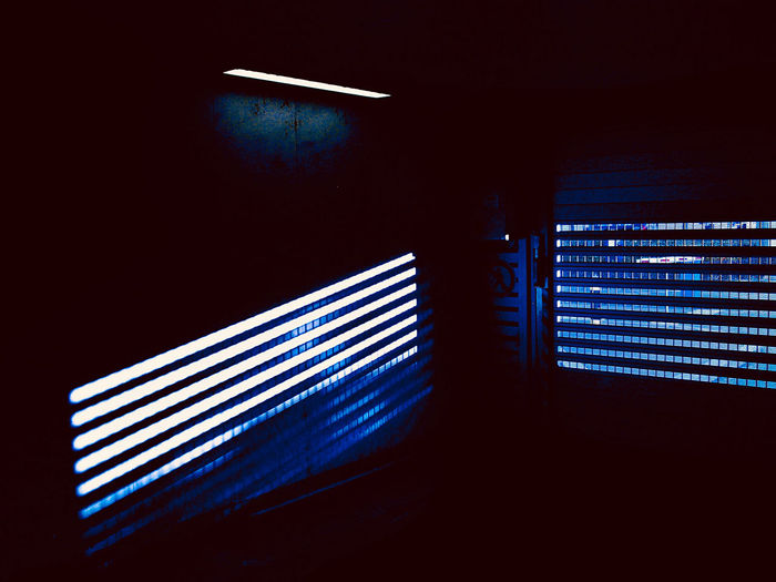 Close-up of illuminated lighting equipment on wall